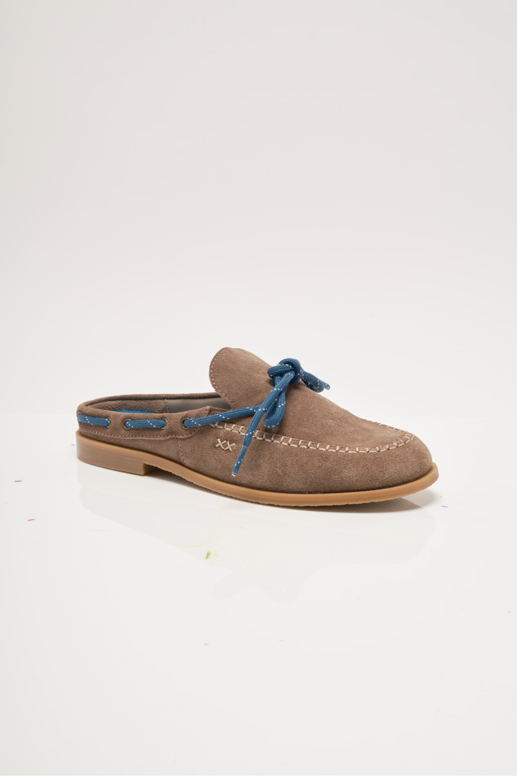 Tan suede mules with blue lace-up tie and stitched moccasin seam