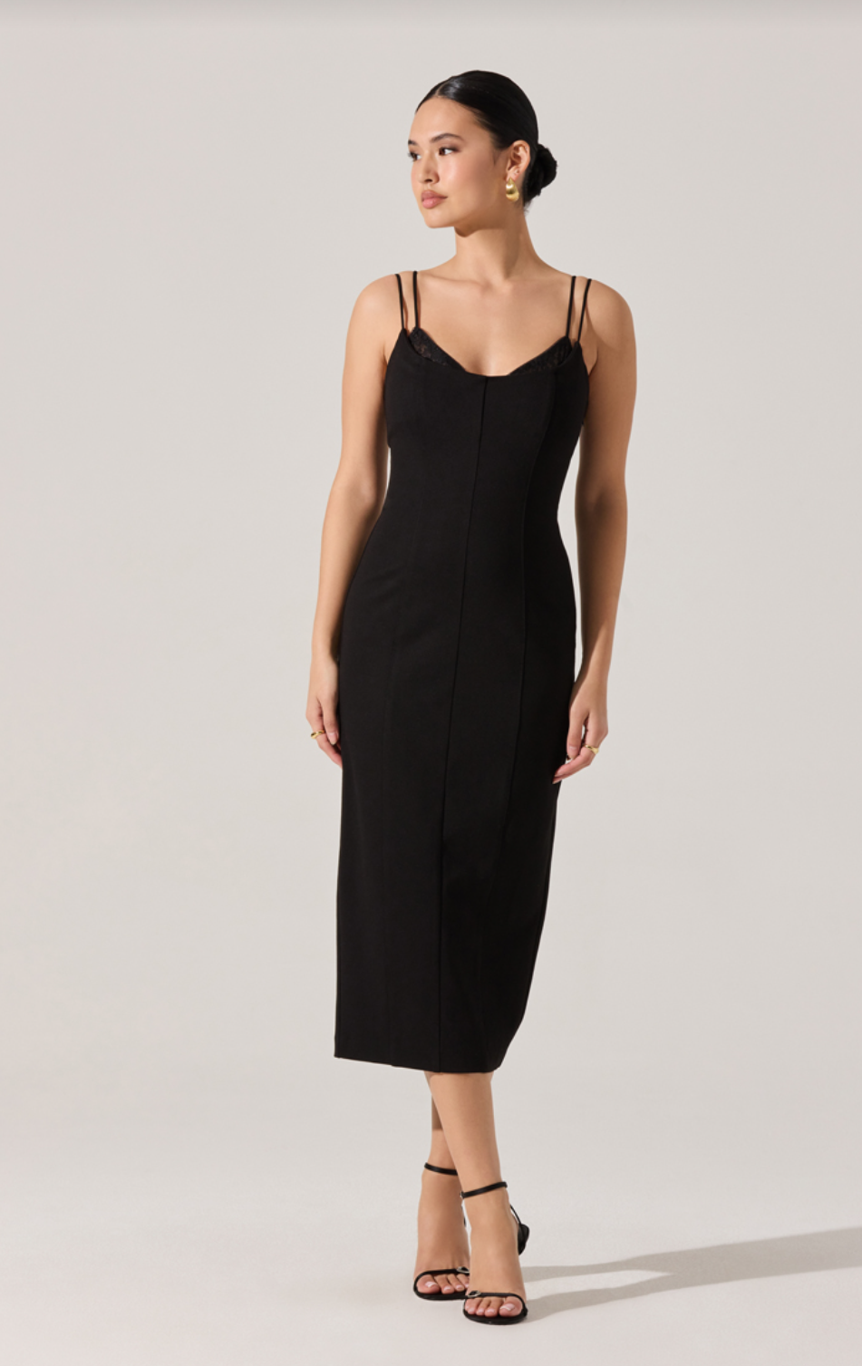 Black midi slip dress with thin spaghetti straps and V-shaped neckline