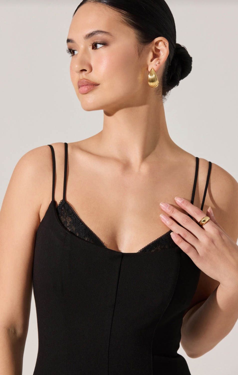 Black midi dress close-up with lace-like bust panel and thin spaghetti straps