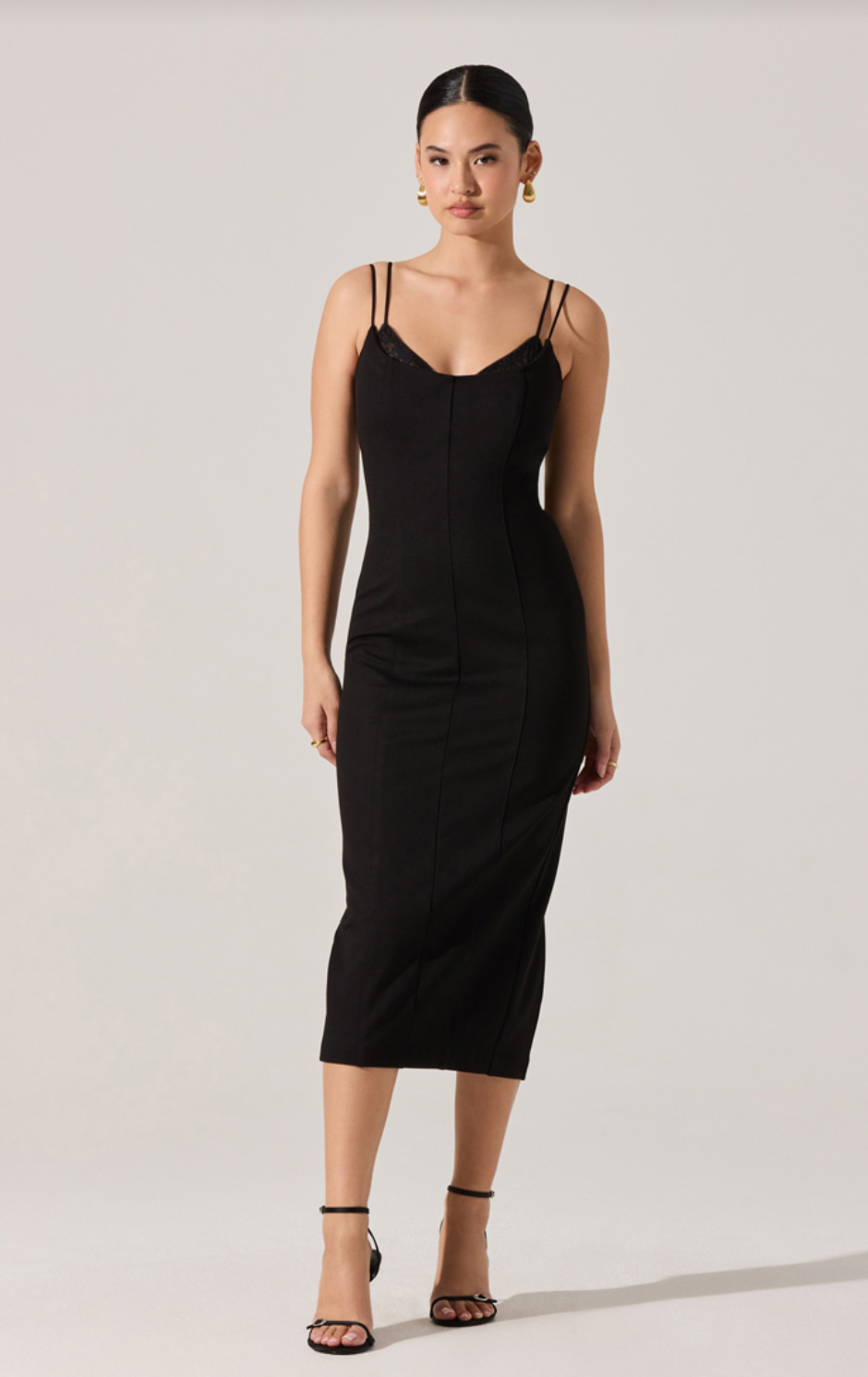 Black midi slip dress with thin spaghetti straps and straight fitted skirt