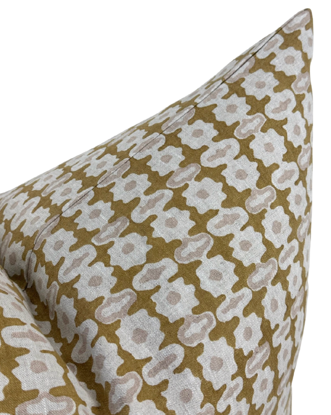 Corner close-up of geometric patterned pillow cover in saffron and cream