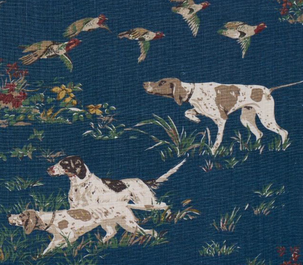 Navy pillow cover print with two hunting dogs and birds among green plants.