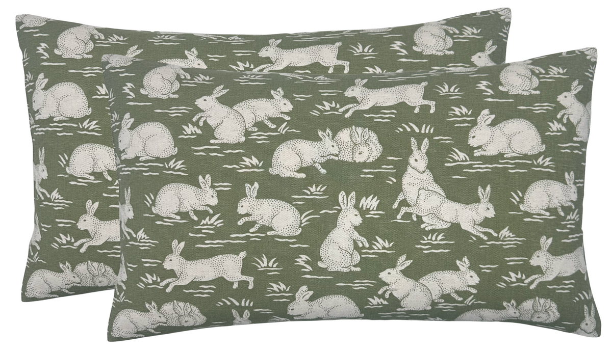 Sage green cotton pillow cover with white rabbit pattern, piped edges