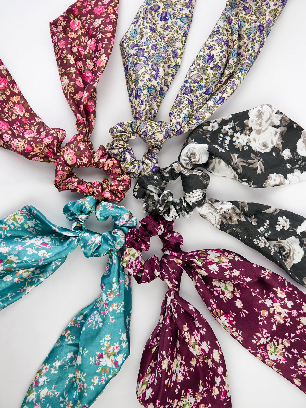 Purple satin floral scarf scrunchie among assorted satin floral scrunchies