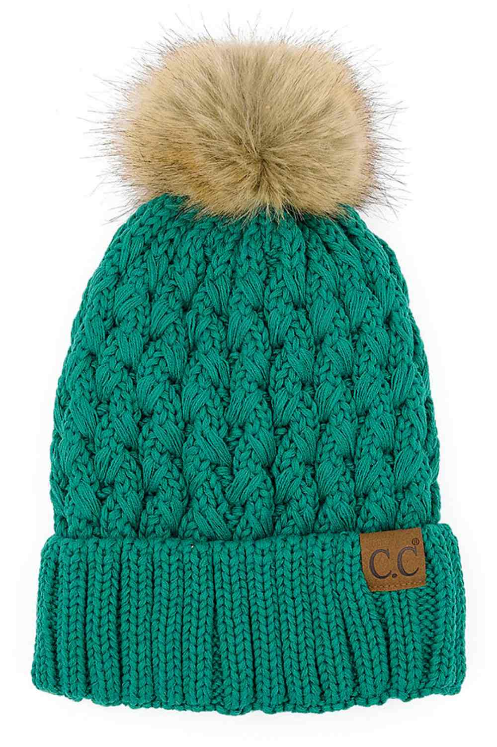 Teal knitted beanie with fluffy pom-pom and C.C patch on ribbed cuff.
