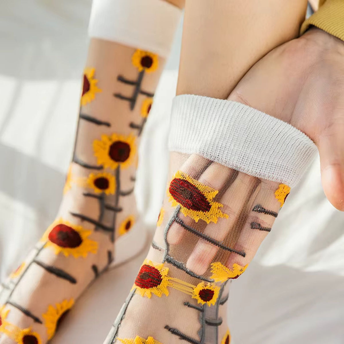 Sheer plant lover socks with sunflower and vine embroidery in yellow and orange accents