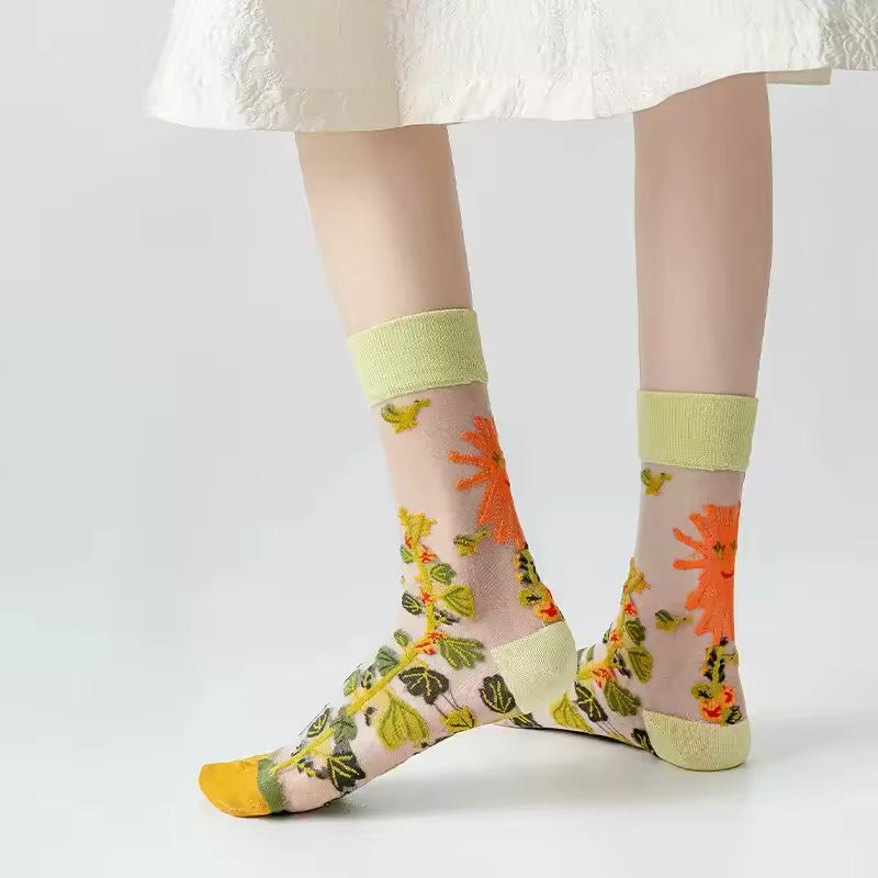Sheer plant lover socks with green and orange flower print, lime knit cuff