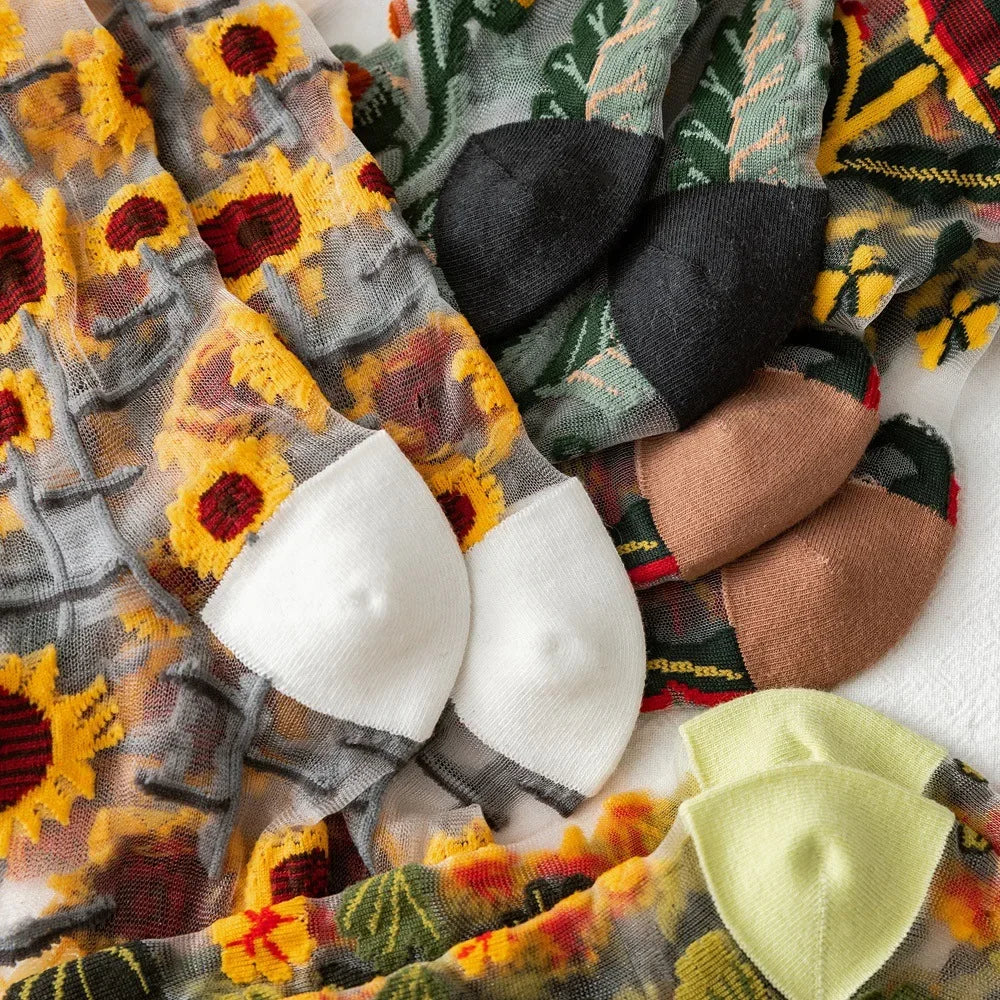 Sheer plant lover socks close-up with embroidered vines in yellow, orange, and red