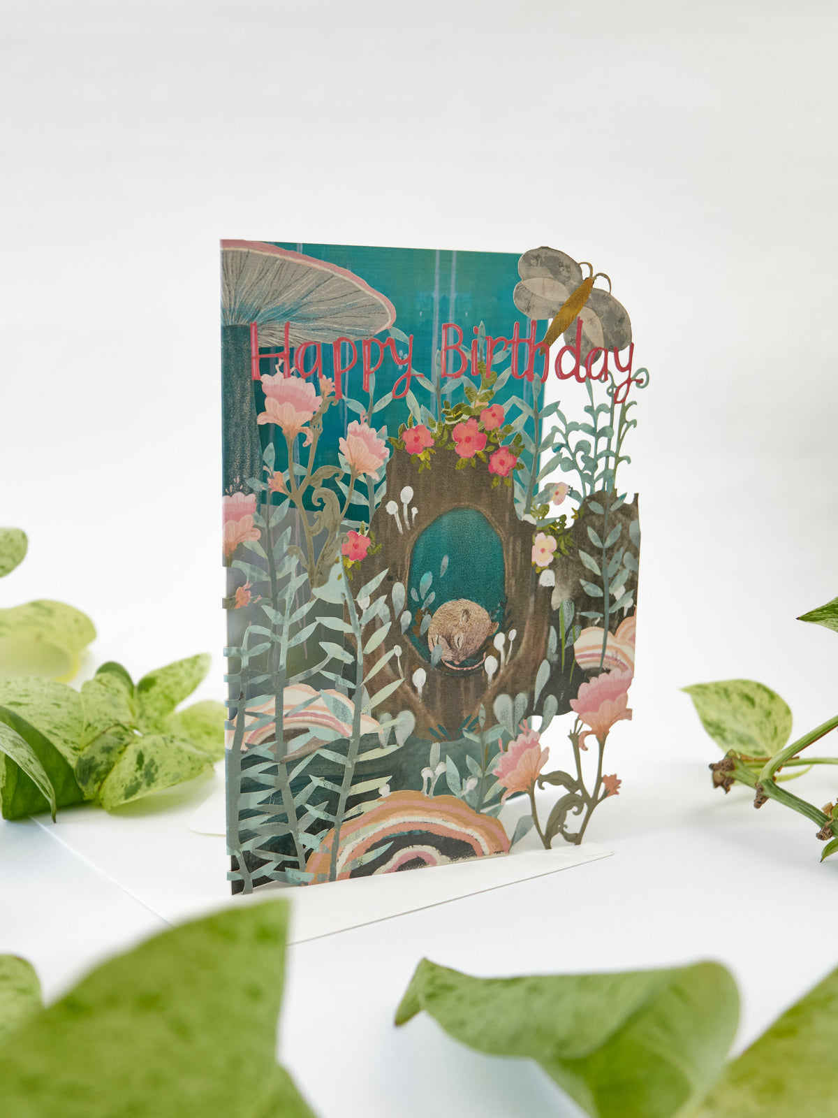 Lasercut birthday card with sleeping dormouse in teal garden, 'Happy Birthday' headline