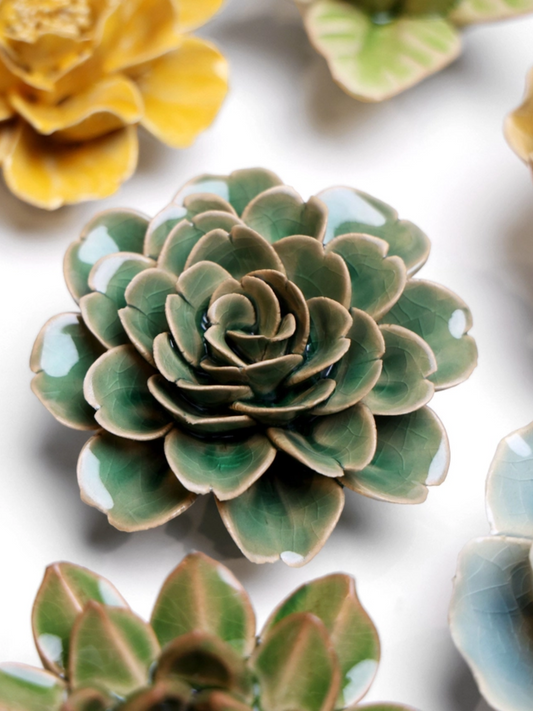 Ceramic green rose-shaped ornament with layered succulent-like petals, dark center