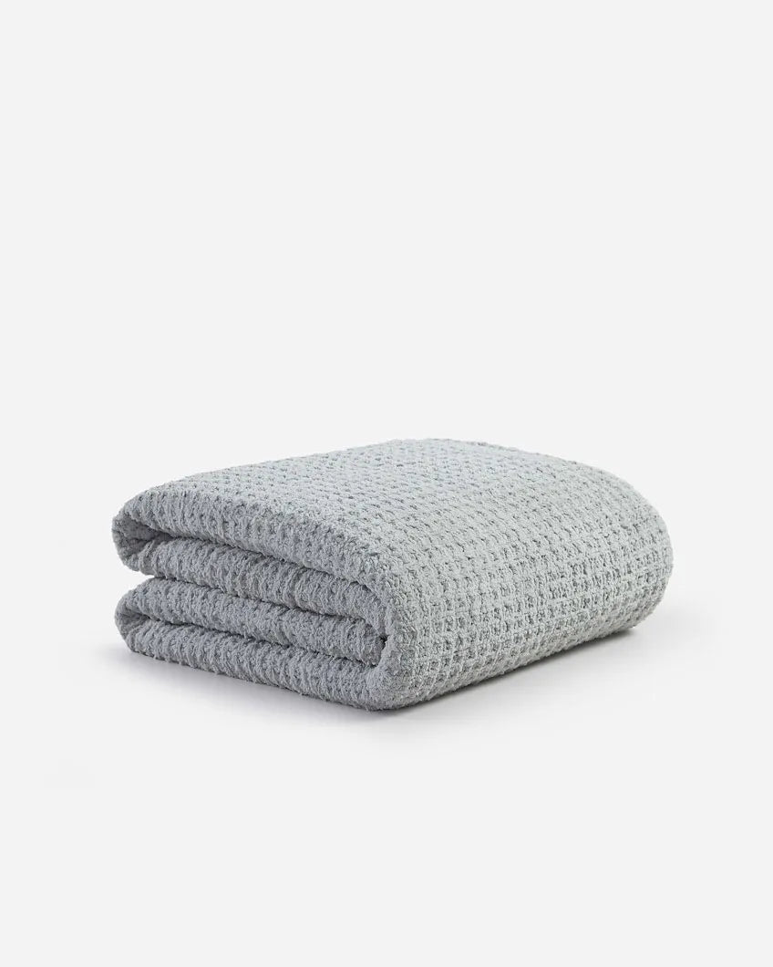 Cloud gray waffle comforter folded stack with textured grid pattern