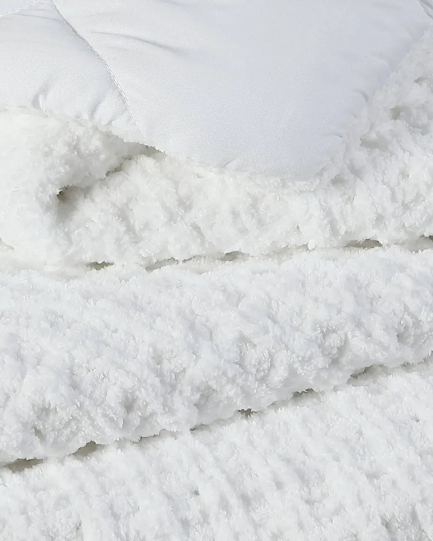 Close-up of white waffle comforter texture with fluffy, raised fabric loops