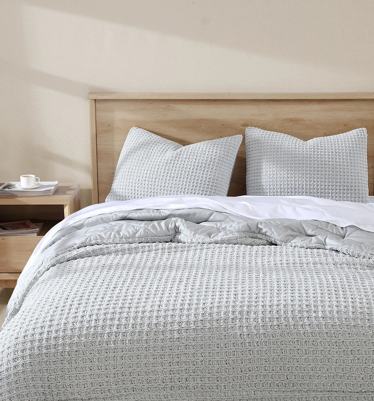 Clear white waffle comforter with matching square shams on a bed
