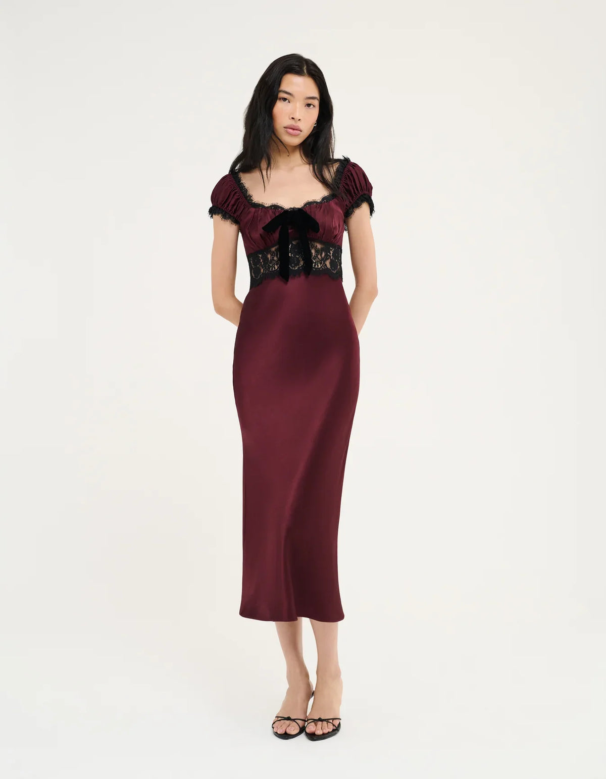 Burgundy midi dress with black lace bodice, off-shoulder puff sleeves, lace bow detail