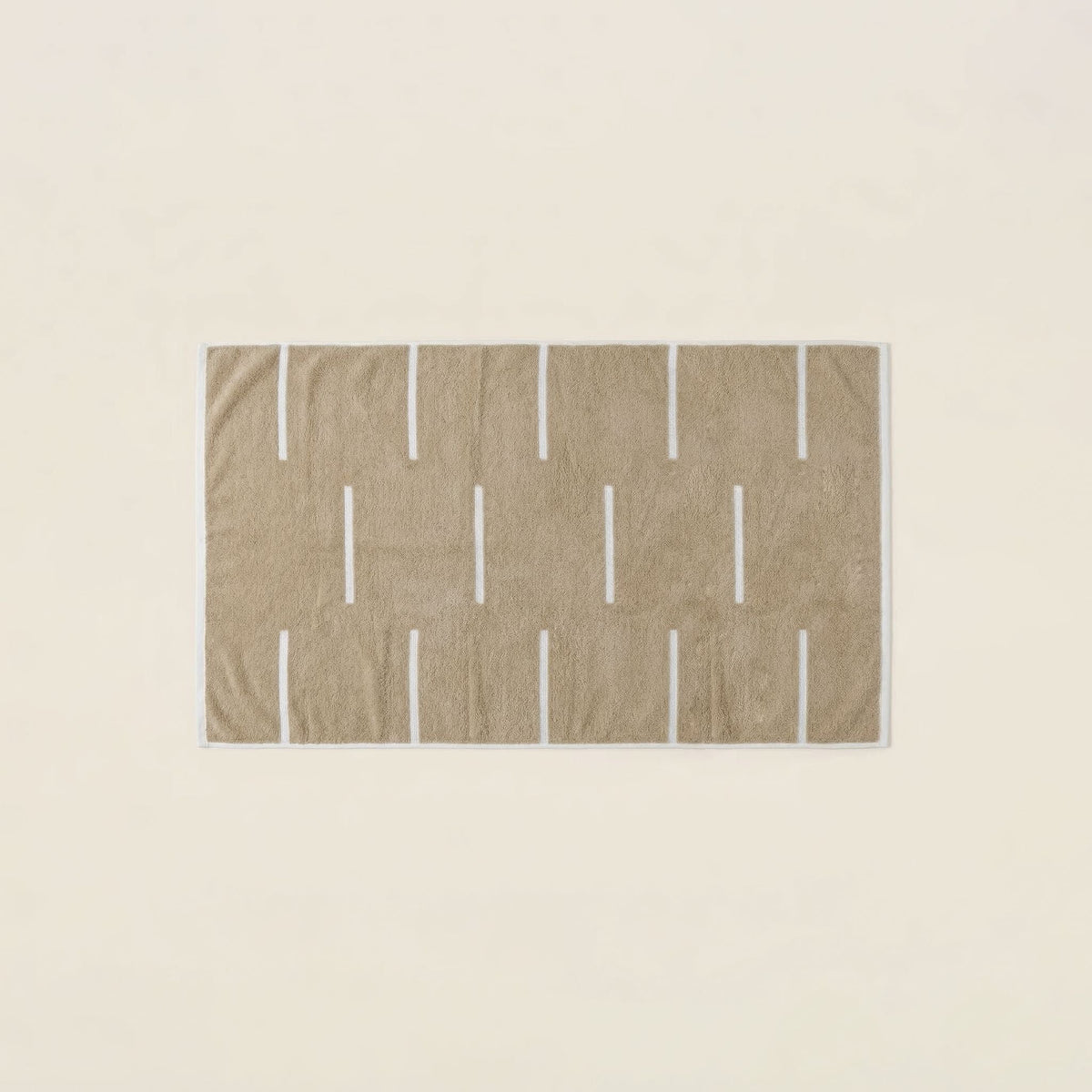 Tan and ecru cotton towel with grid-like vertical stripe pattern