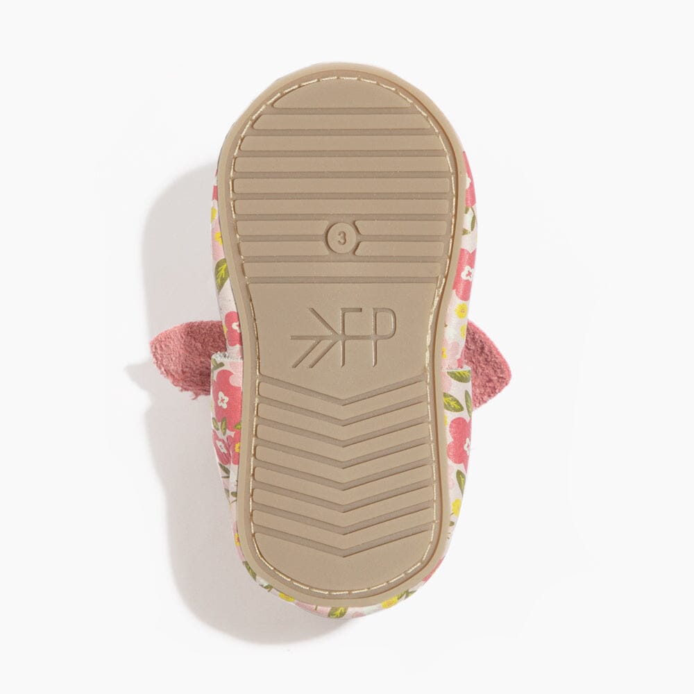 Bottom view of baby floral shoe showing grippy outsole with soft sole grip