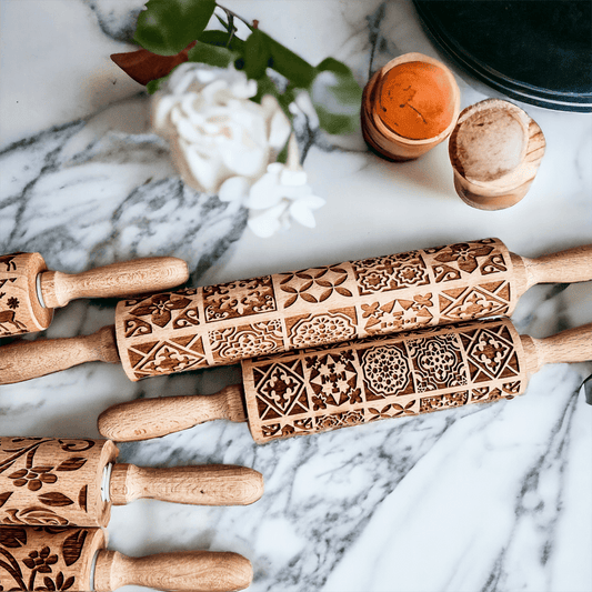 Decorative rolling pin set on marble with wood handles and brown patterned sleeves