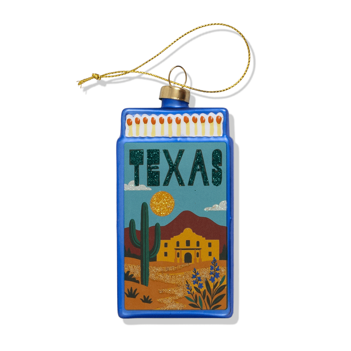 Blue Texas-themed matchbook ornament with cactus, desert scene, and gold sparkly details