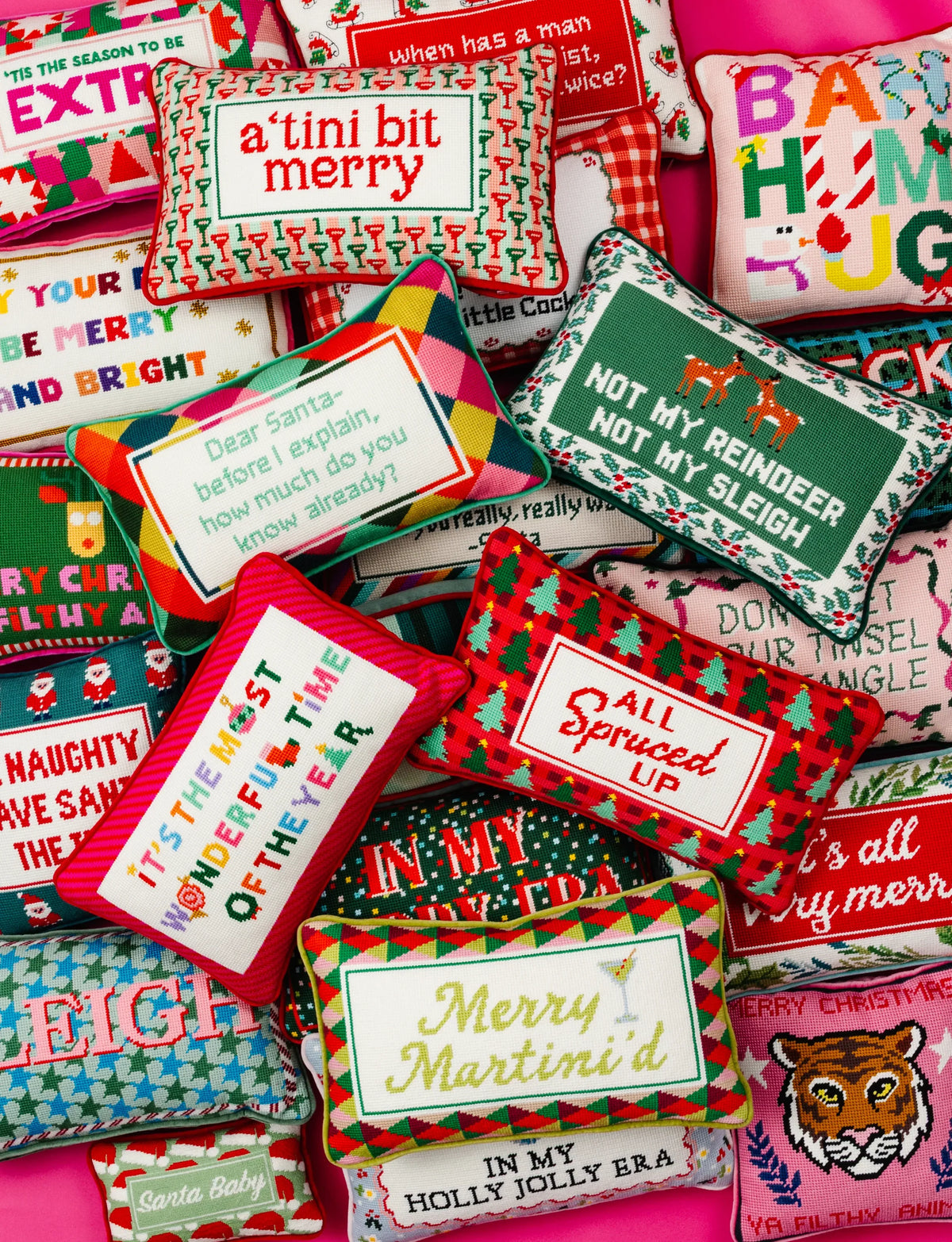 Pack of Christmas needlepoint pillows with varied sayings and 'All Spruced Up' designs