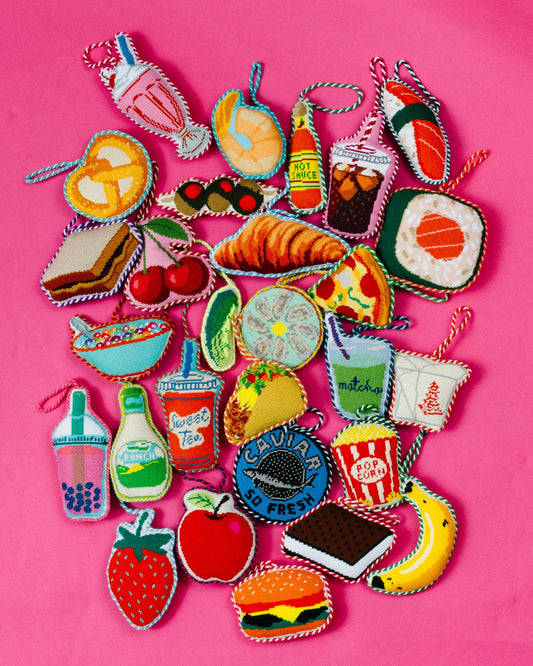 Assorted needlepoint food ornaments, including a stitched taco shape