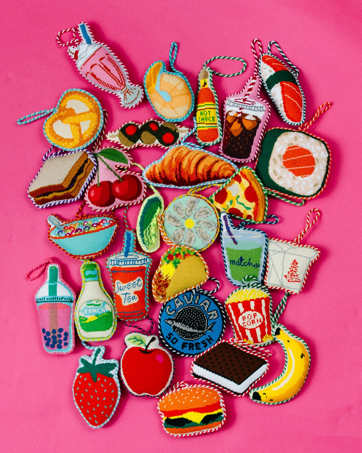 Needlepoint icon ornaments assortment, colorful stitched shapes with hanging loops.