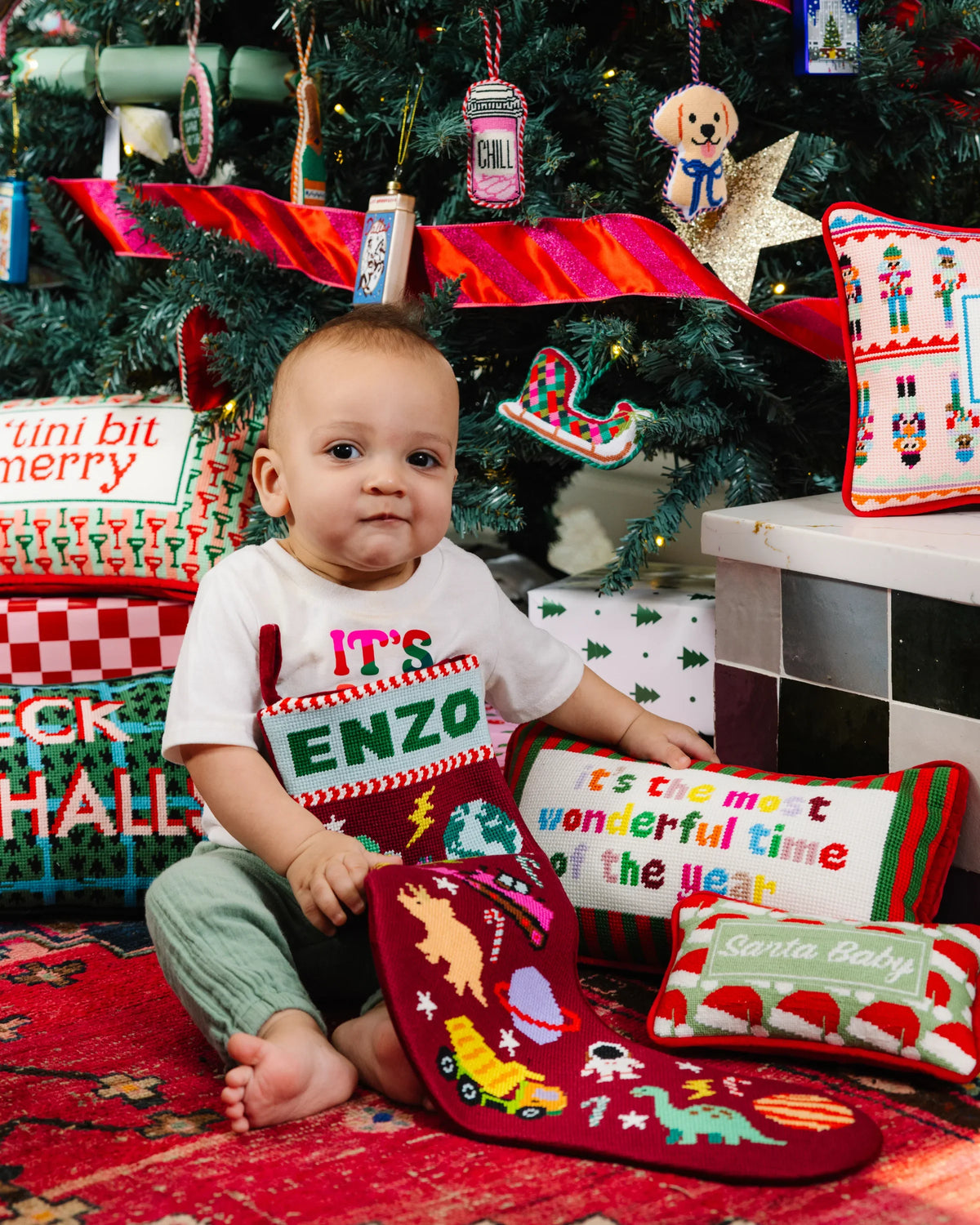 Santa Baby mini needlepoint pillow on holiday scene, red and green needlepoint design