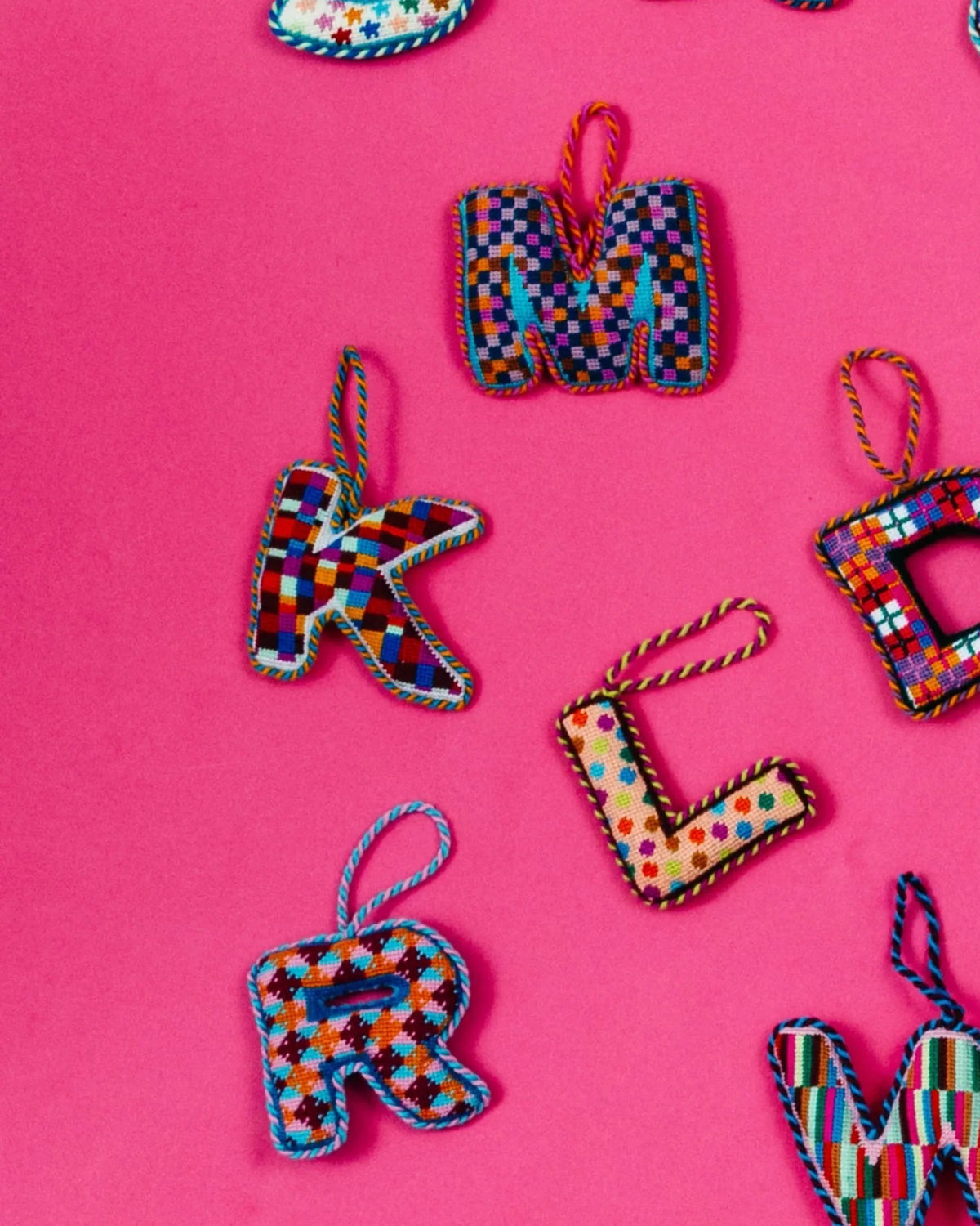 Needlepoint monogram ornament K with multicolor check pattern and hanging loop