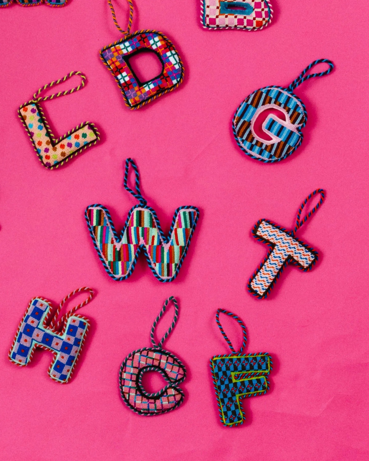 Needlepoint monogram T ornament with colorful stitched pattern and hanging ribbon loop