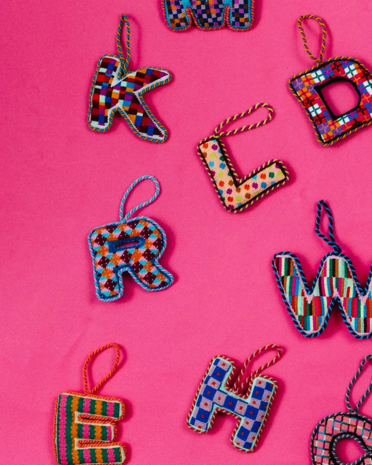 Needlepoint letter R ornament with multicolor stitched pattern and hanging loop