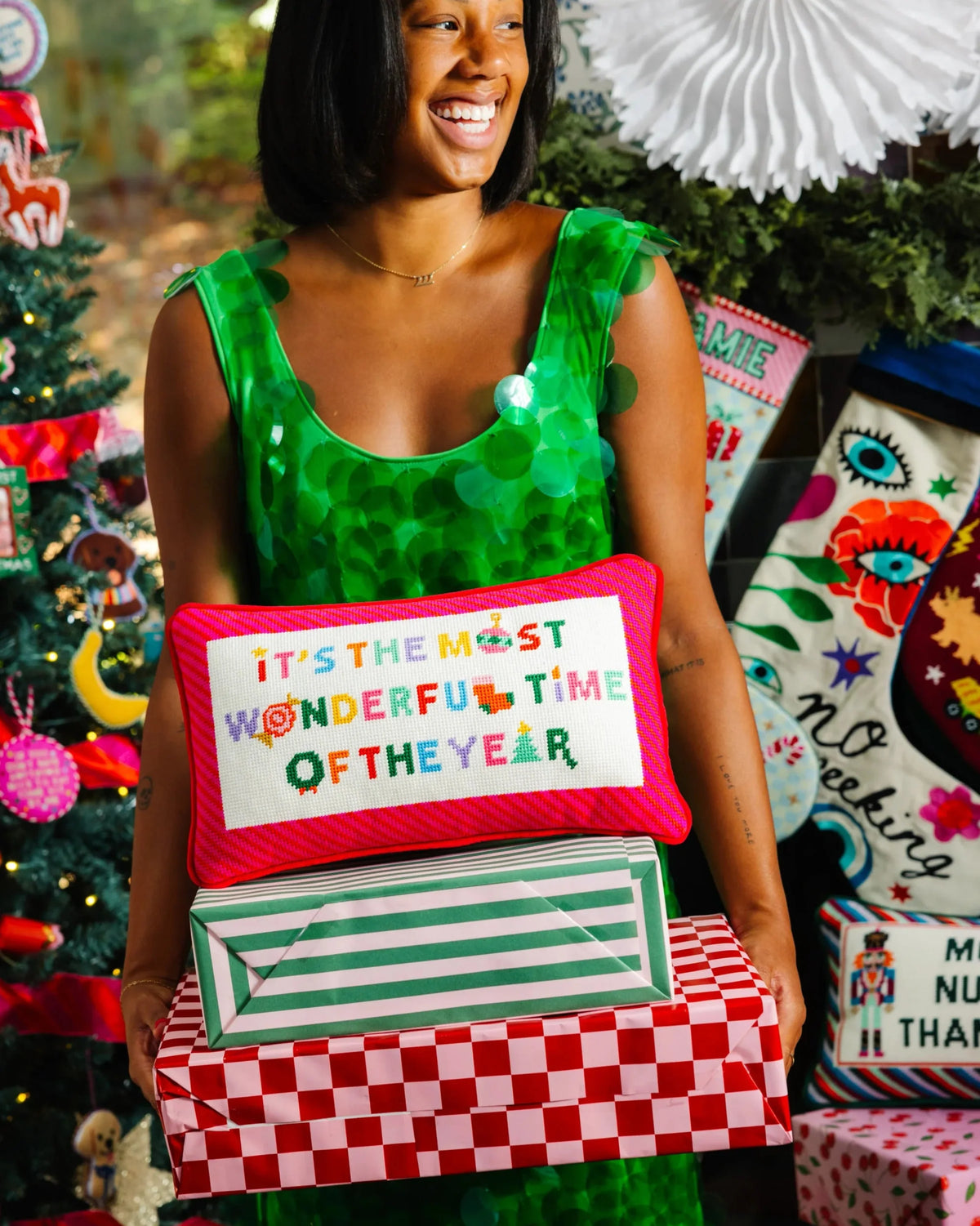 Needlepoint throw pillow with red trim and "It's the most wonderful time of the year".