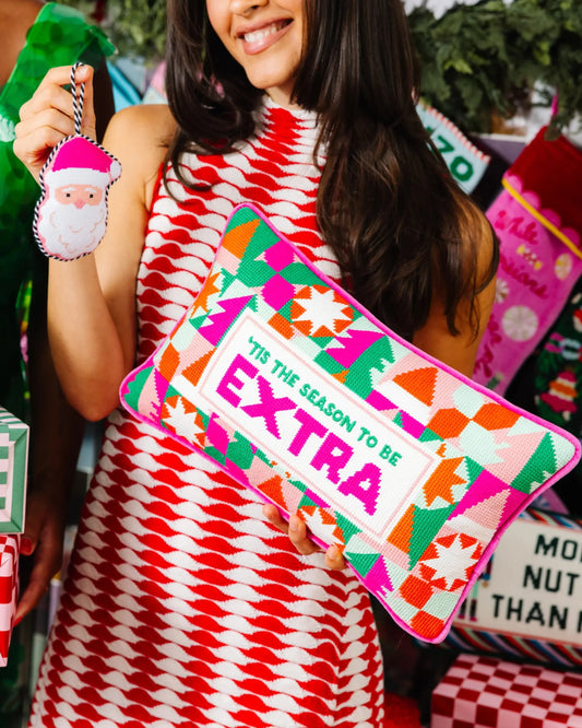Rectangular needlepoint holiday pillow with 'TIS THE SEASON TO BE EXTRA' text.