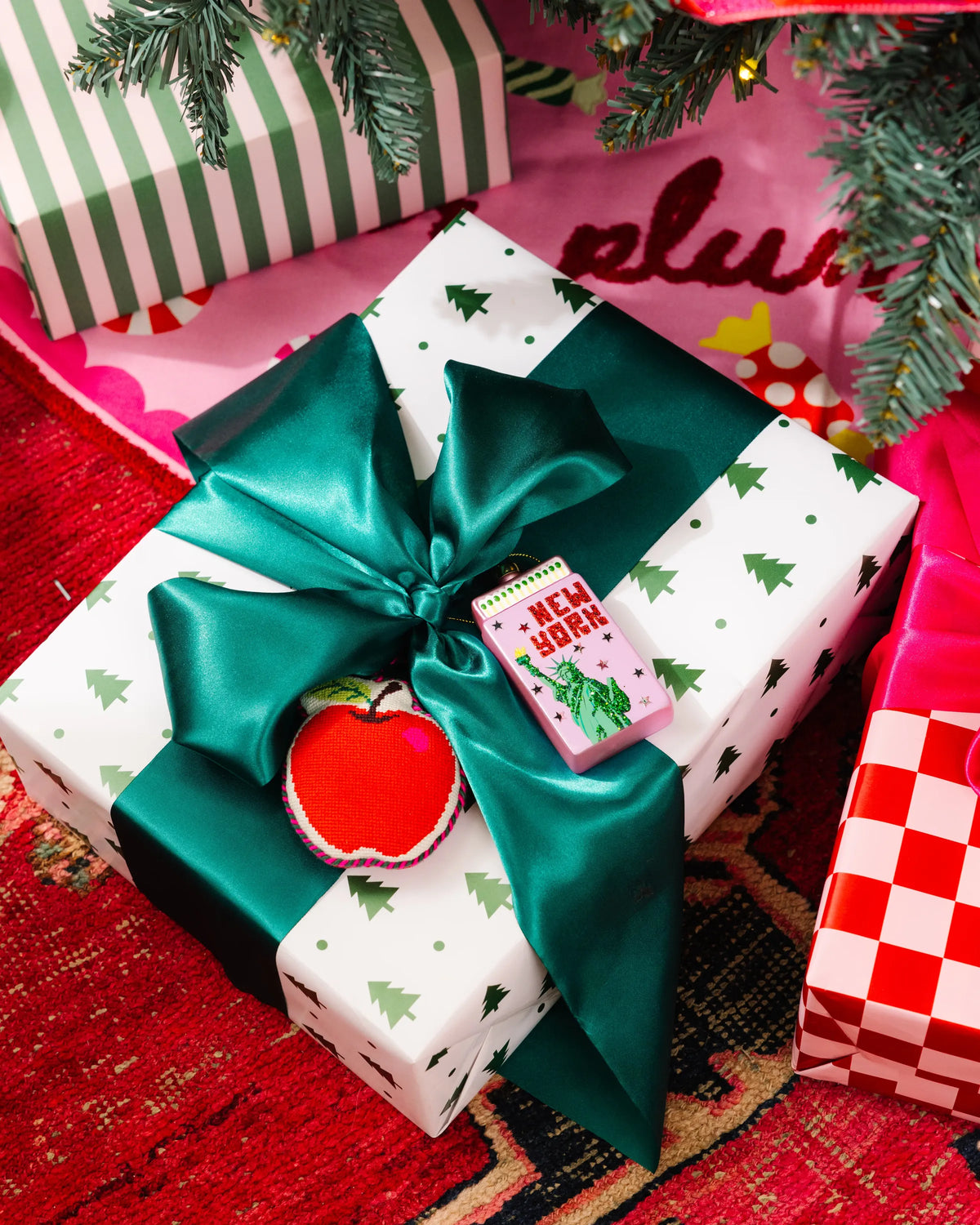 New York matchbook ornament on wrapped gift with green bow and star accents