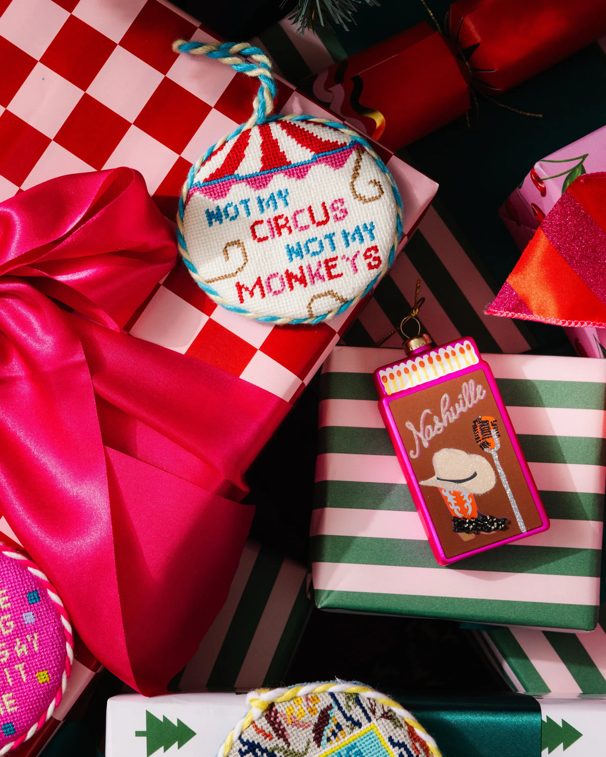 Pink matchbook ornament on a gift box amid holiday decorations