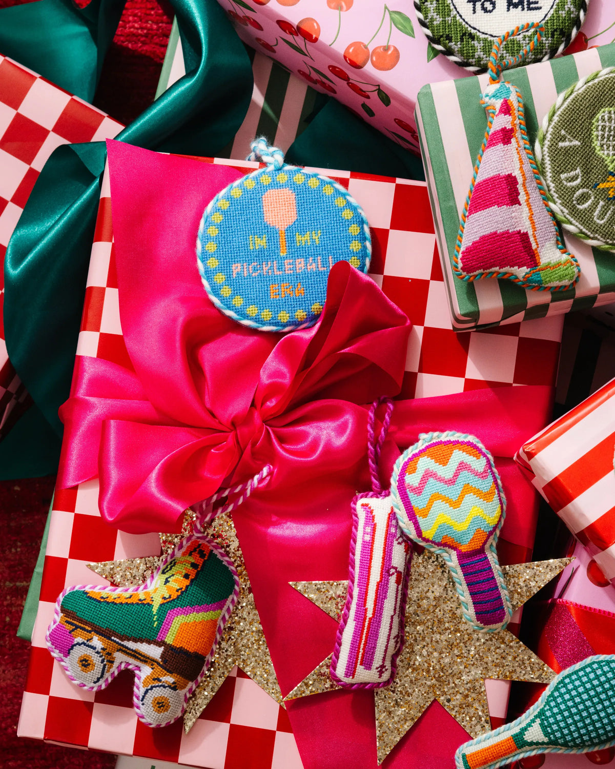 Needlepoint roller skate icon ornament with rainbow details on patterned wrapping