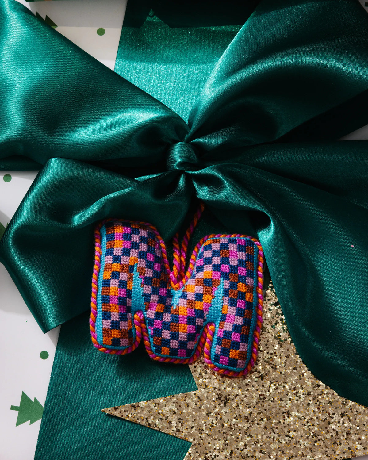 Needlepoint monogram ornament M with multicolor checkered stitching and hanging loop