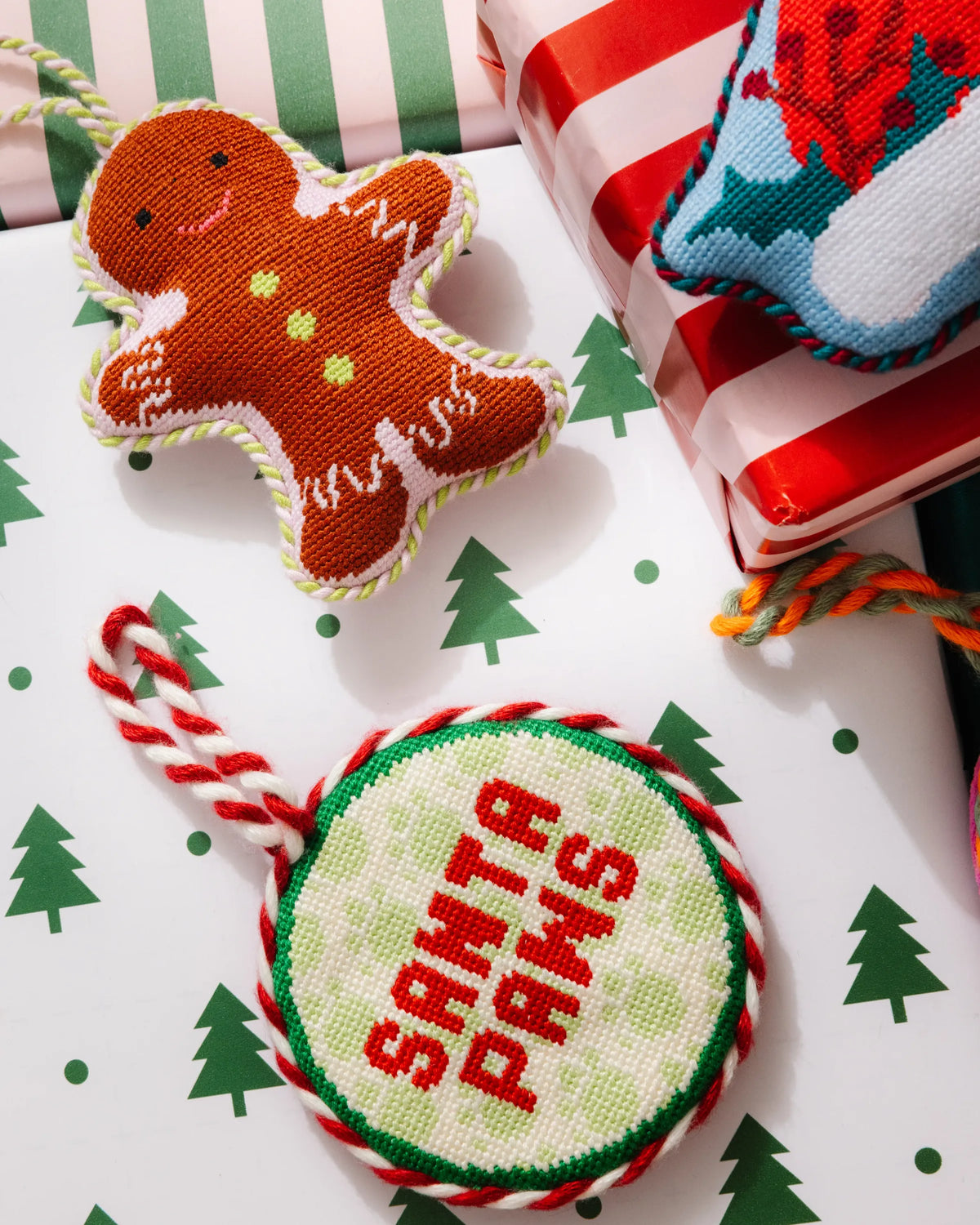 Needlepoint gingerbread man ornament, stitched white icing details and loop