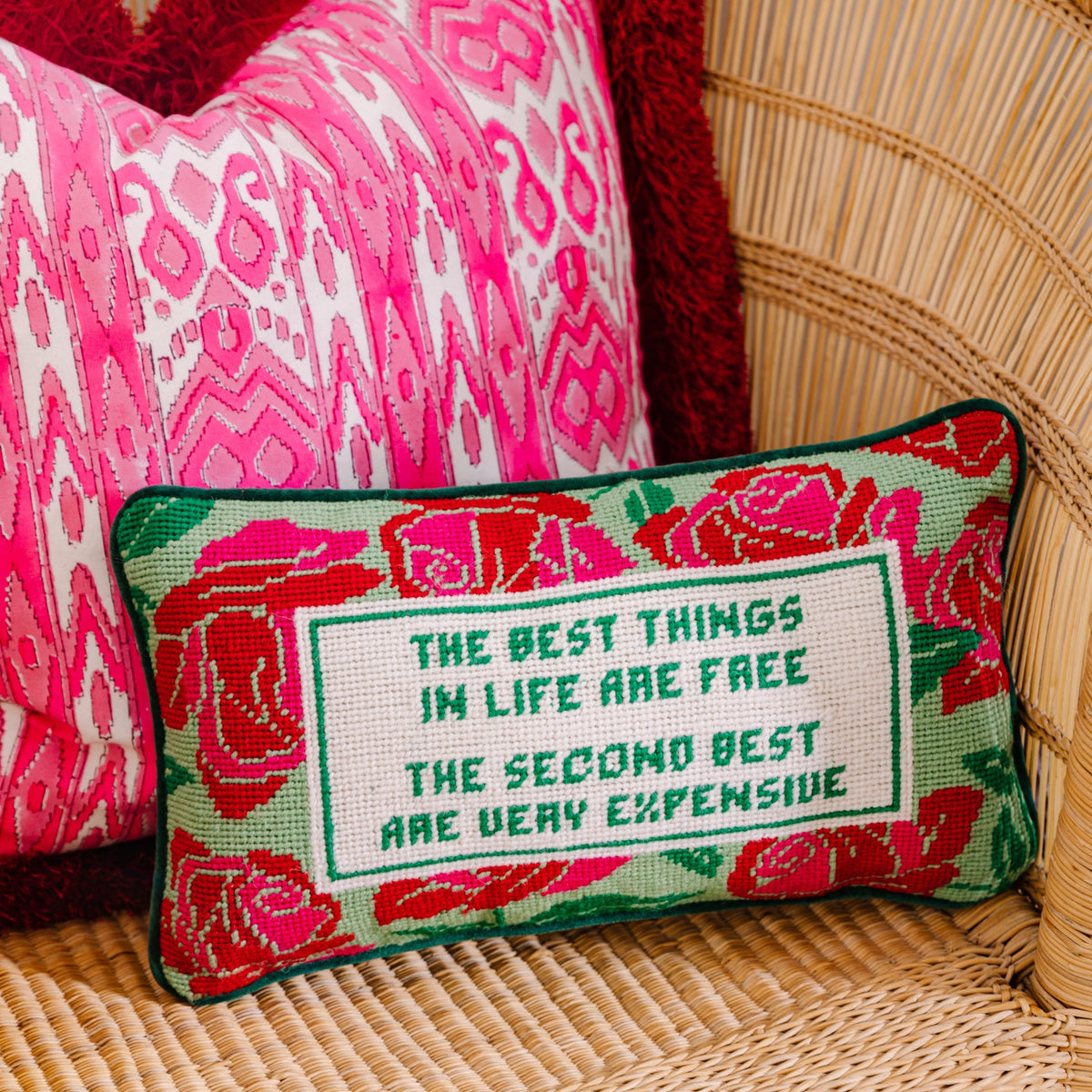 Embroidered needlepoint throw pillow, green and red floral border with centered quote text