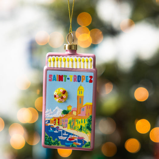 Pink matchbook ornament hanging with gold cord and St. Tropez scene