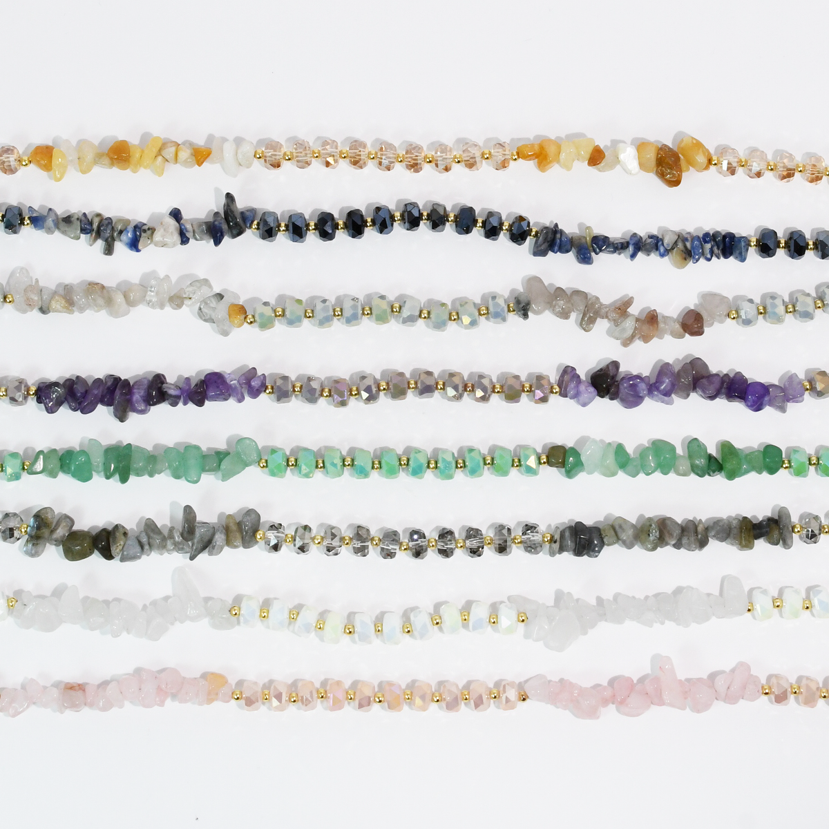 Multiple beaded quartz necklaces in assorted colors, each with gold-tone spacer beads.