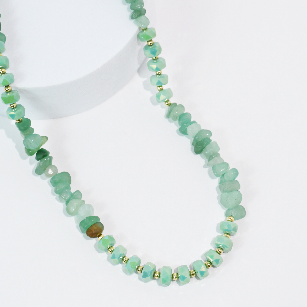 Mint green beaded quartz necklace with faceted stones and gold-tone spacer beads.