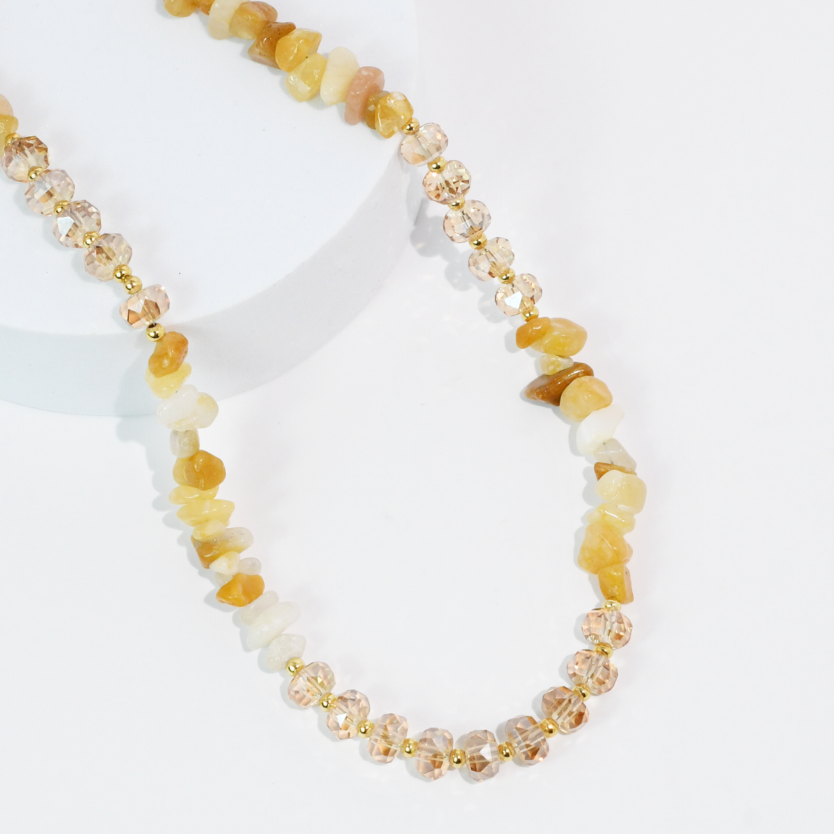 Amber/gold beaded quartz necklace with faceted stones and gold-tone spacer beads.