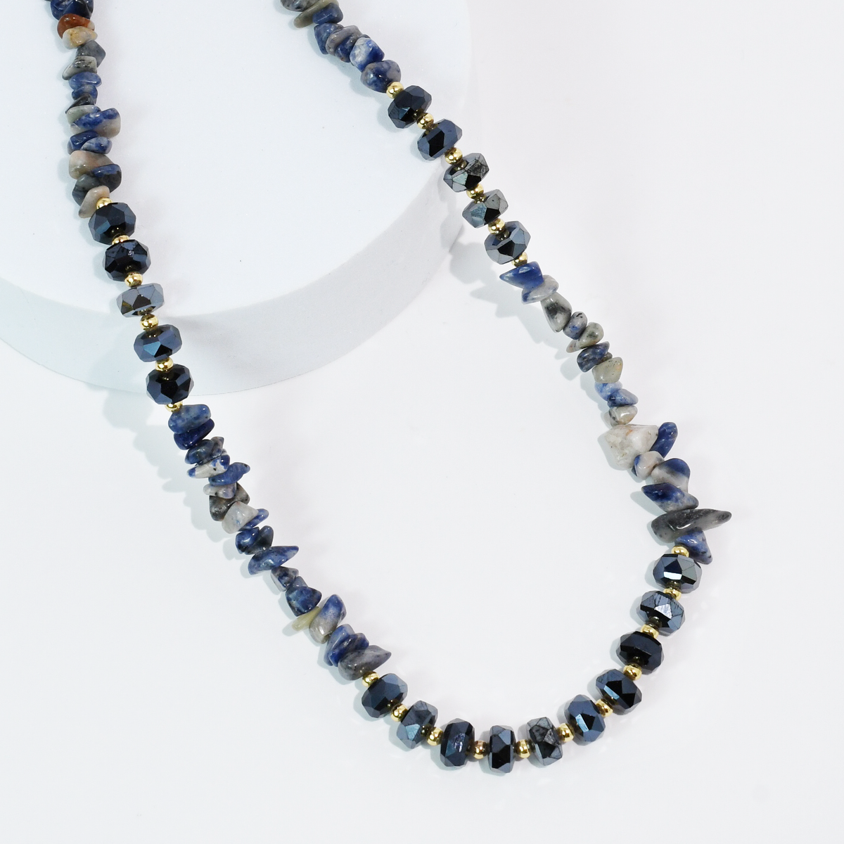 Navy blue beaded quartz necklace with dark faceted stones and gold-tone spacer beads.