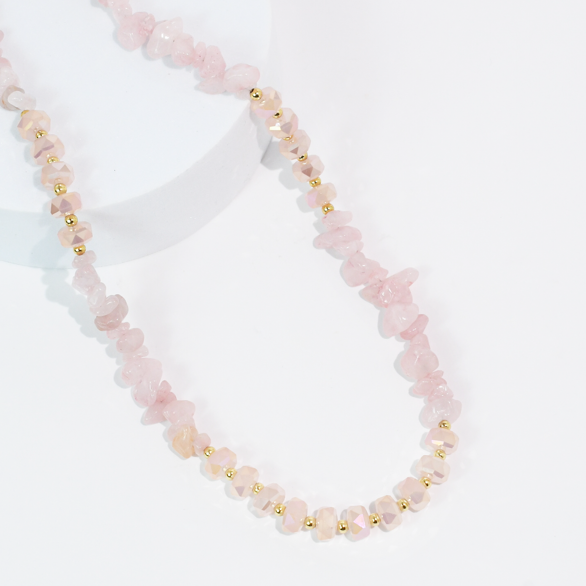 Pink beaded quartz necklace with faceted stones and small gold-tone spacer beads.