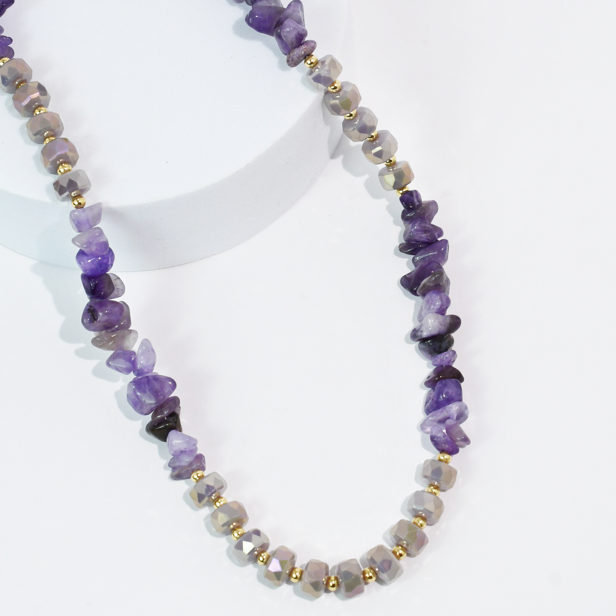 Purple beaded quartz necklace with faceted stones and gold-tone spacer beads.