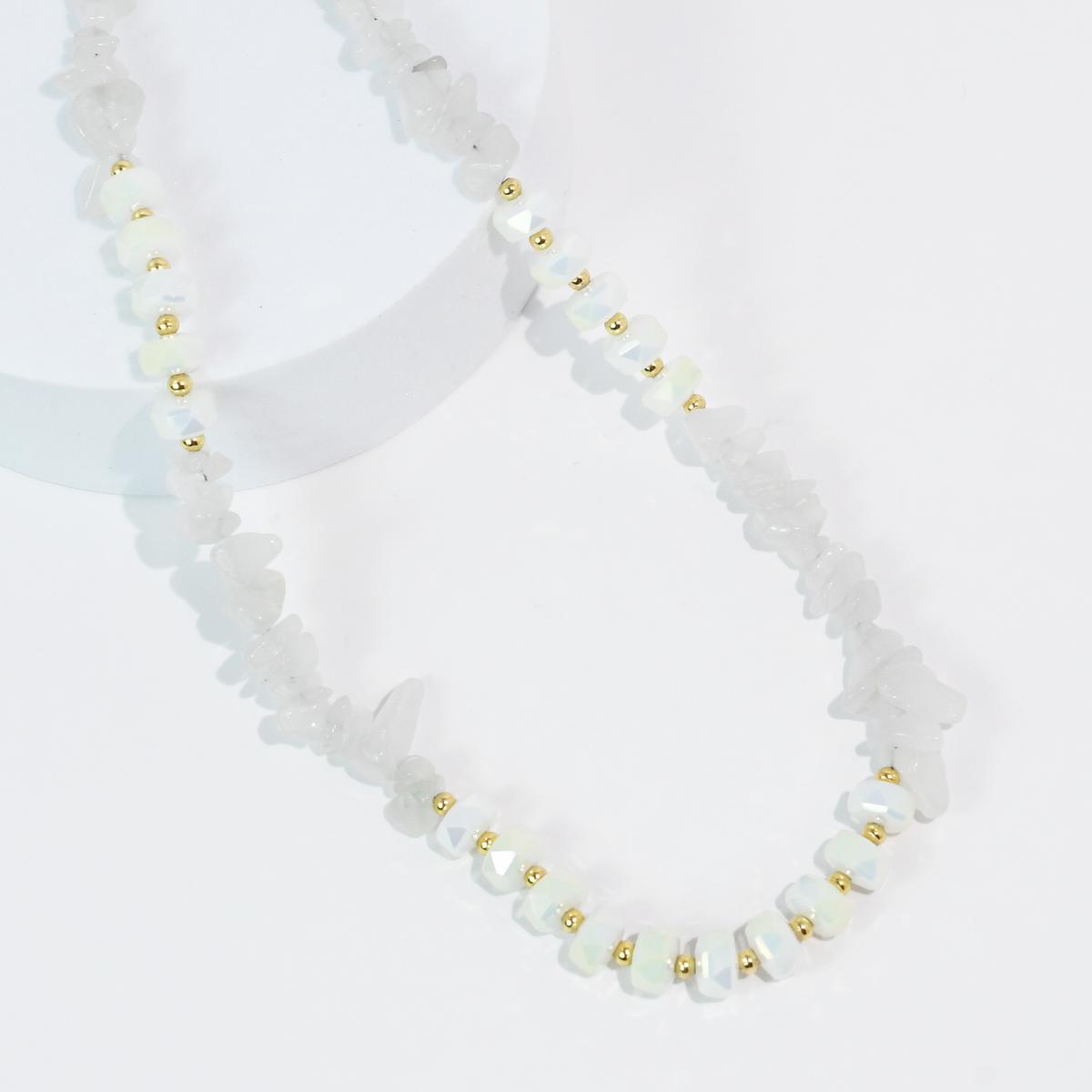 White beaded quartz necklace with faceted stones and small gold-tone spacer beads.