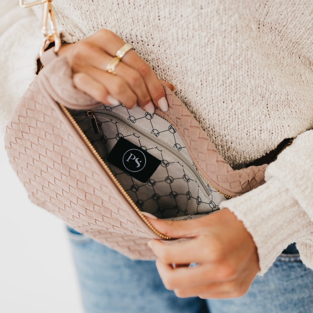 Suede Westlyn woven bum bag in blush pink, open zip reveals patterned lining.