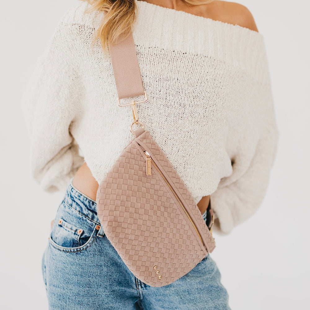 Suede Westlyn woven bum bag in blush pink, zip top and adjustable crossbody strap.
