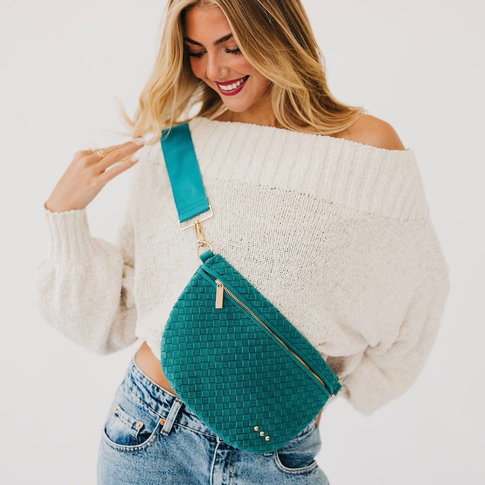 Suede Westlyn woven bum bag in teal, zip top and adjustable crossbody strap.