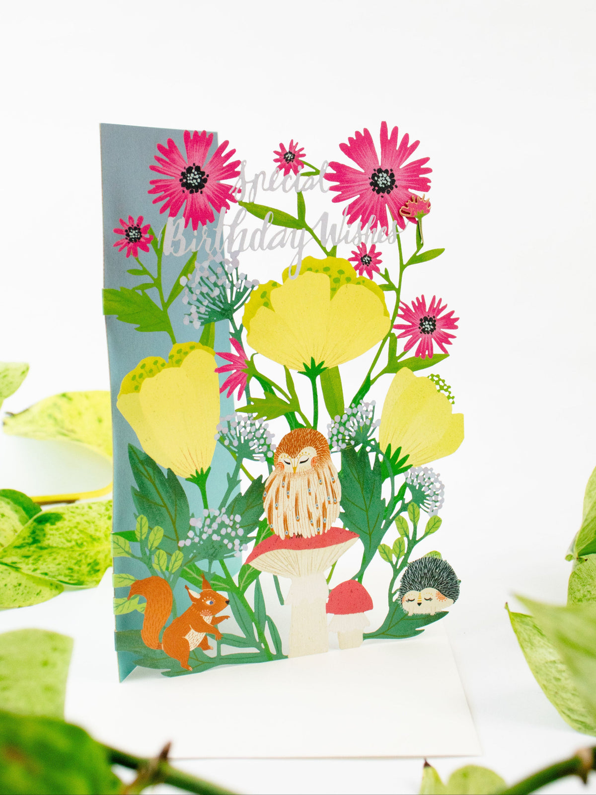 Floral lasercut birthday card with pink flowers, yellow leaves, lion, and girl