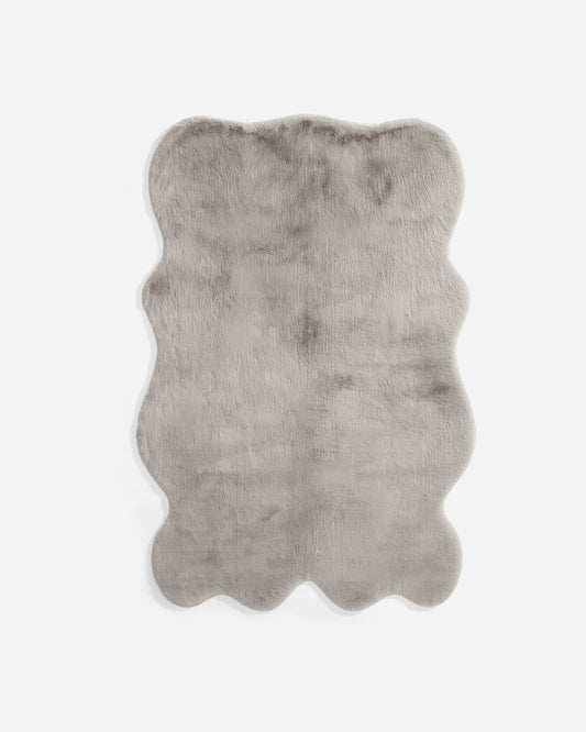 Grey faux fur large rug with wavy edges and soft shag pile